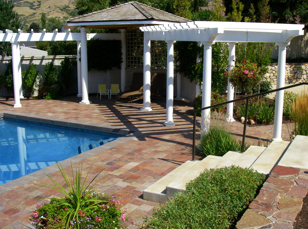 Inspiration for a medium sized traditional back rectangular lengths swimming pool in Salt Lake City with a pool house and tiled flooring.