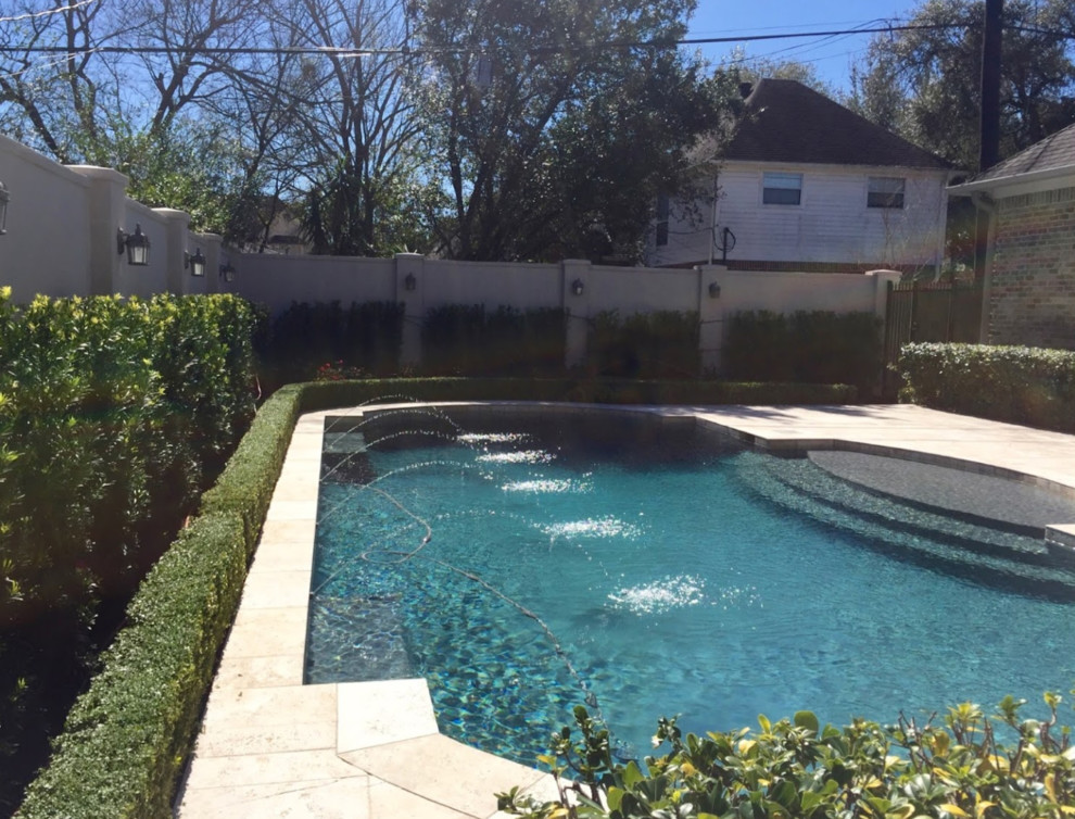 Large elegant backyard stone and rectangular lap pool fountain photo in Houston