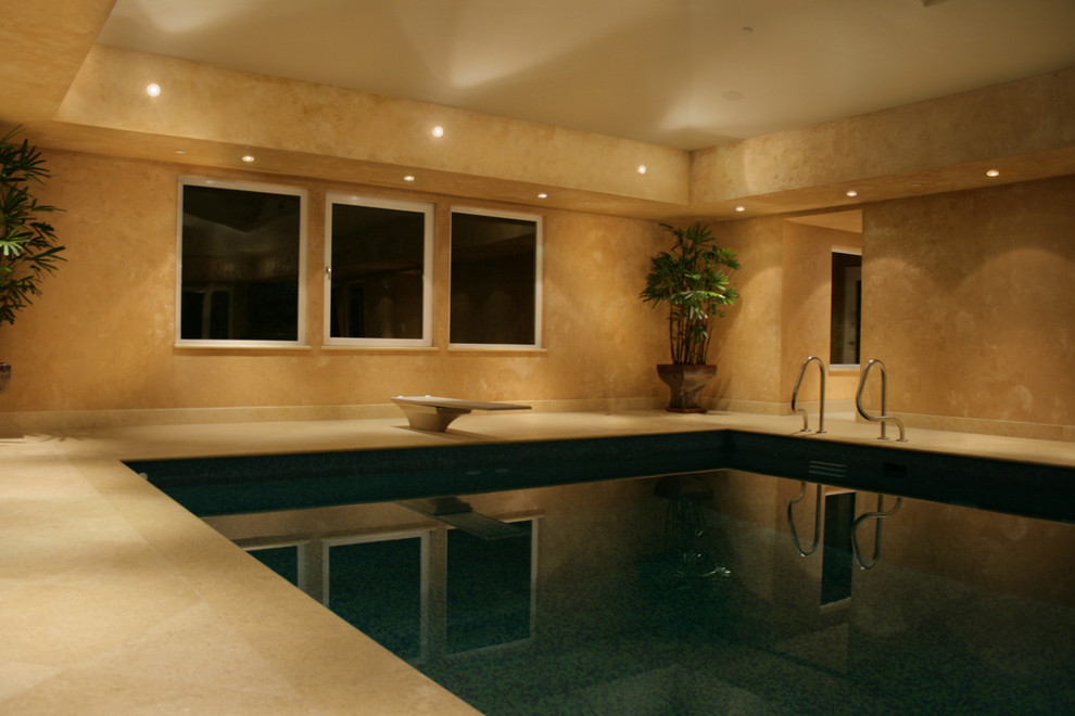 Photo of an expansive contemporary rectangular swimming pool in Calgary with tiled flooring.