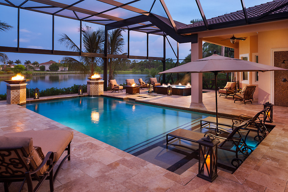 Large tuscan backyard rectangular pool photo in Miami
