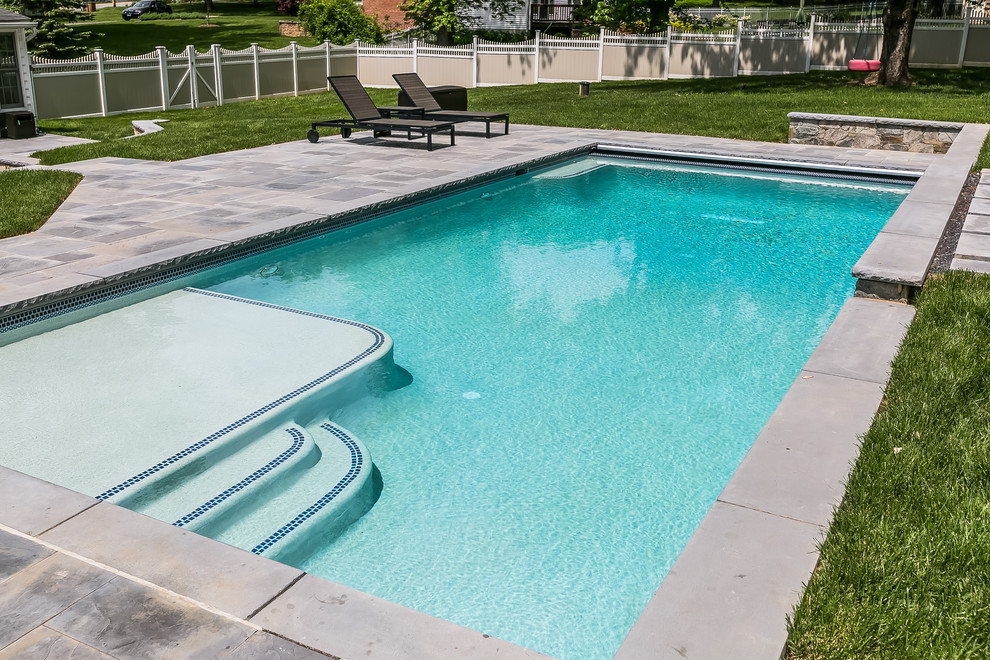 Design ideas for a medium sized traditional back rectangular lengths swimming pool in Baltimore with natural stone paving.