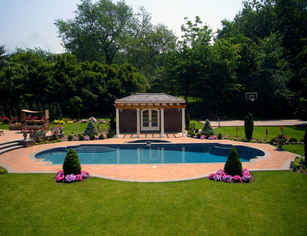 Example of a mid-sized classic backyard stone and custom-shaped lap pool design in New York