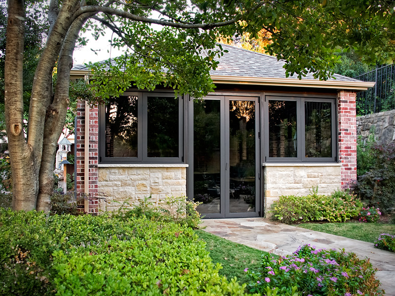 Example of a mid-sized classic backyard concrete and rectangular pool house design in Dallas