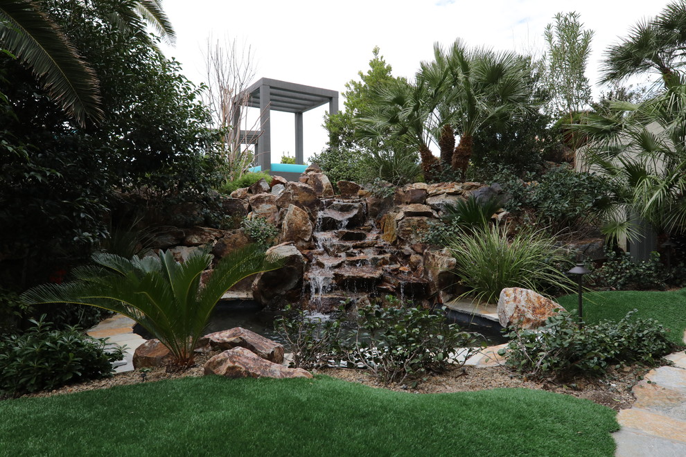 Inspiration for an expansive world-inspired back garden in Las Vegas with a water feature and natural stone paving.