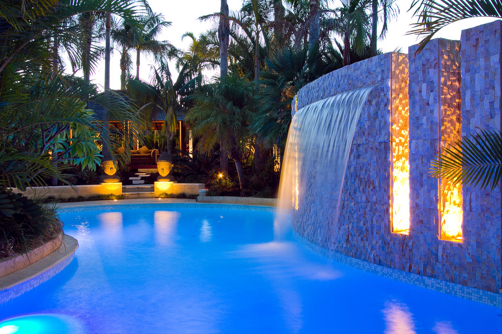 Immagine di una grande piscina tropicale personalizzata dietro casa