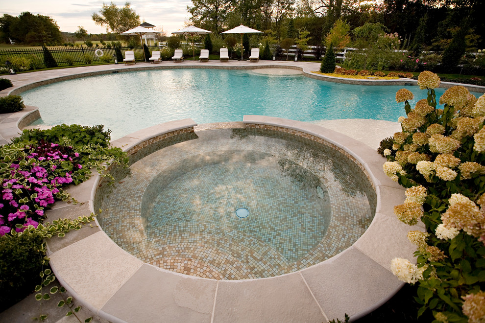 Exemple d'une piscine arrière tendance avec un bain bouillonnant et des pavés en béton.
