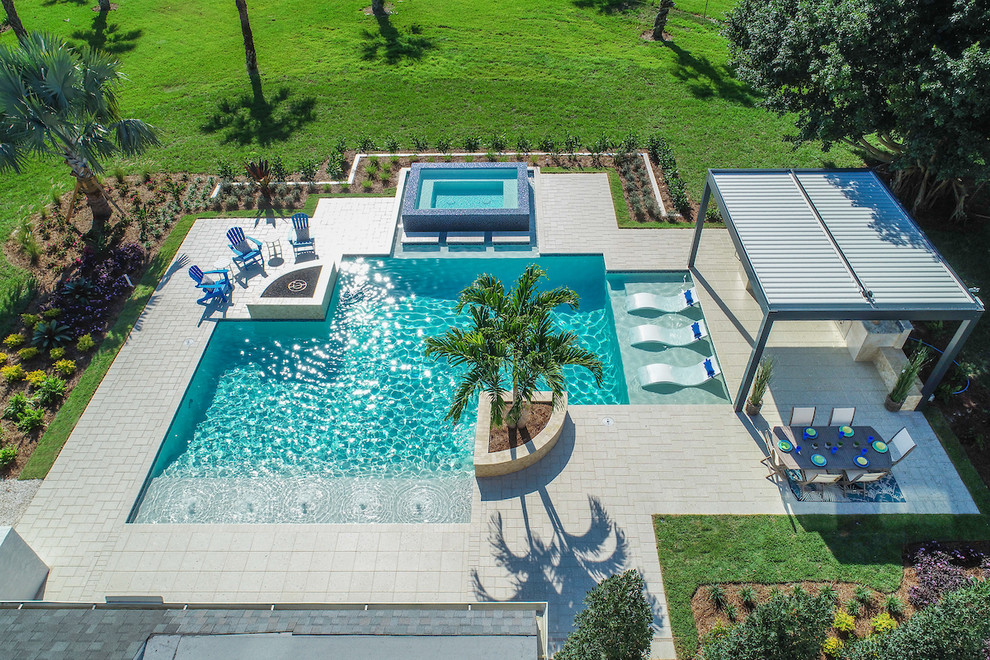 Mid-sized trendy backyard concrete paver lap hot tub photo in Miami