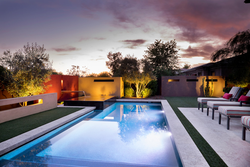 Inspiration for a medium sized contemporary back rectangular swimming pool in Phoenix with a water feature and tiled flooring.