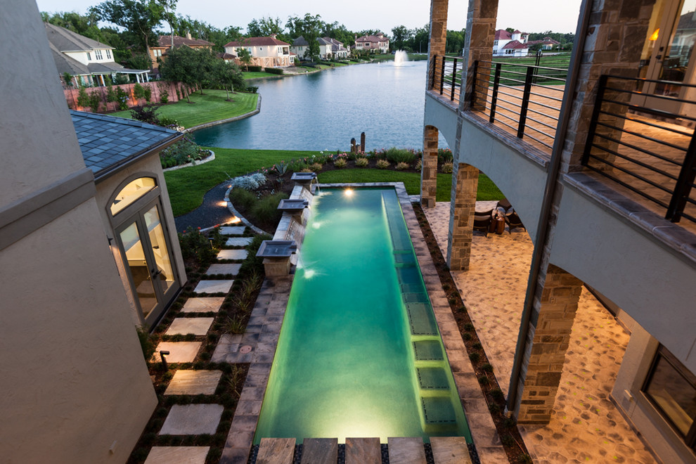 Inspiration for a timeless tile and rectangular pool remodel in Houston
