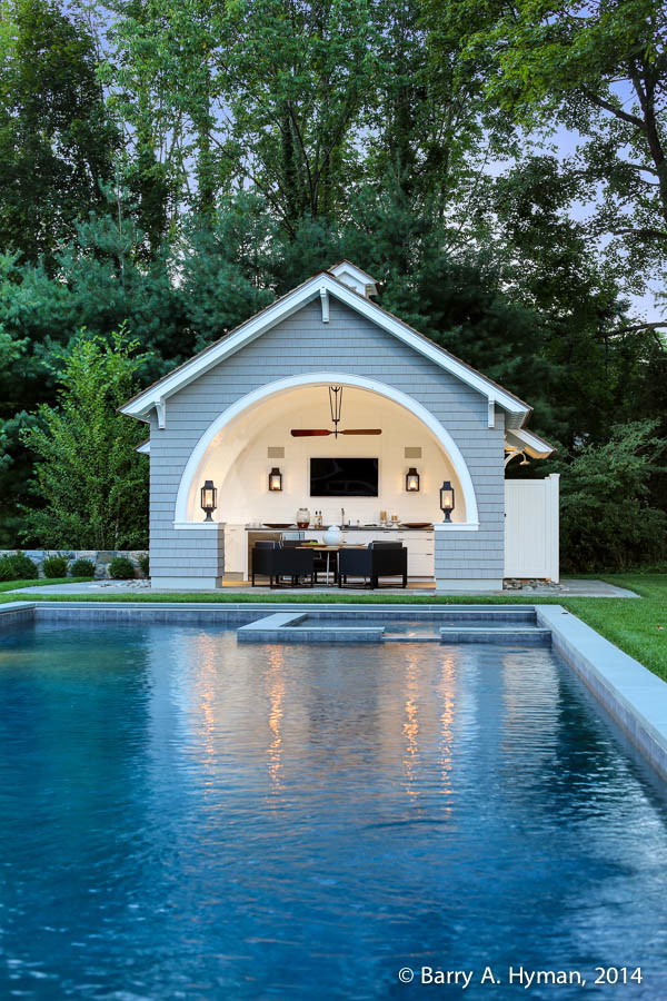 Small classic swimming pool in New York with a pool house.