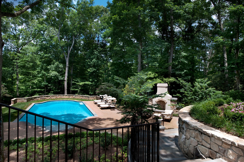 Photo of a large classic back rectangular lengths swimming pool in DC Metro with brick paving.