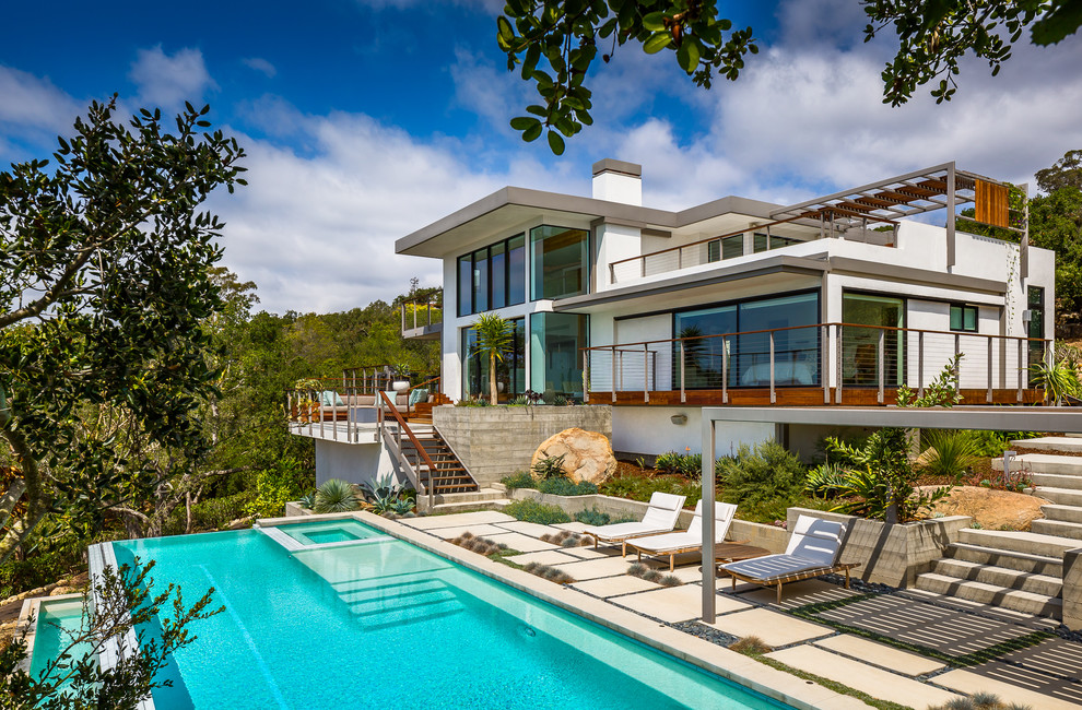Example of a trendy backyard rectangular infinity pool design in Santa Barbara