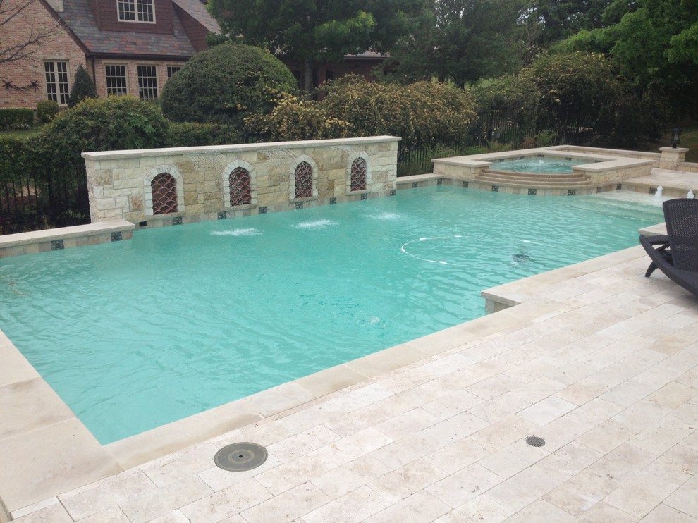 Large mediterranean back rectangular lengths hot tub in Dallas with natural stone paving.