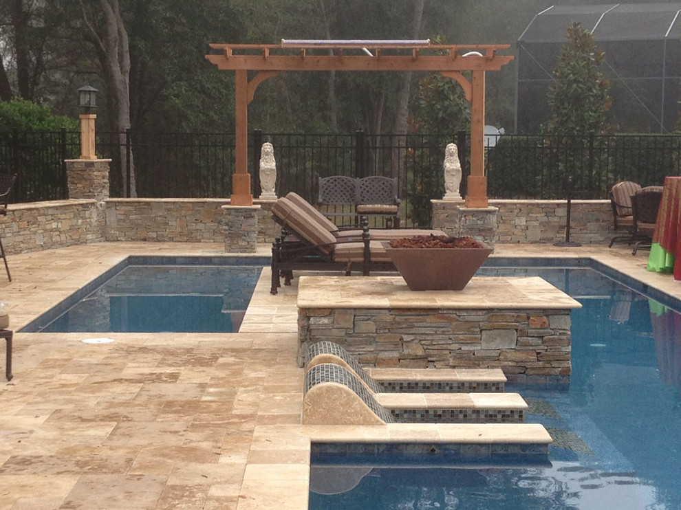 Mid-sized tuscan backyard stone and custom-shaped lap pool fountain photo in Other