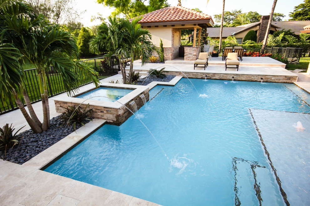 Hot tub - mid-sized contemporary backyard stone and rectangular natural hot tub idea in Miami