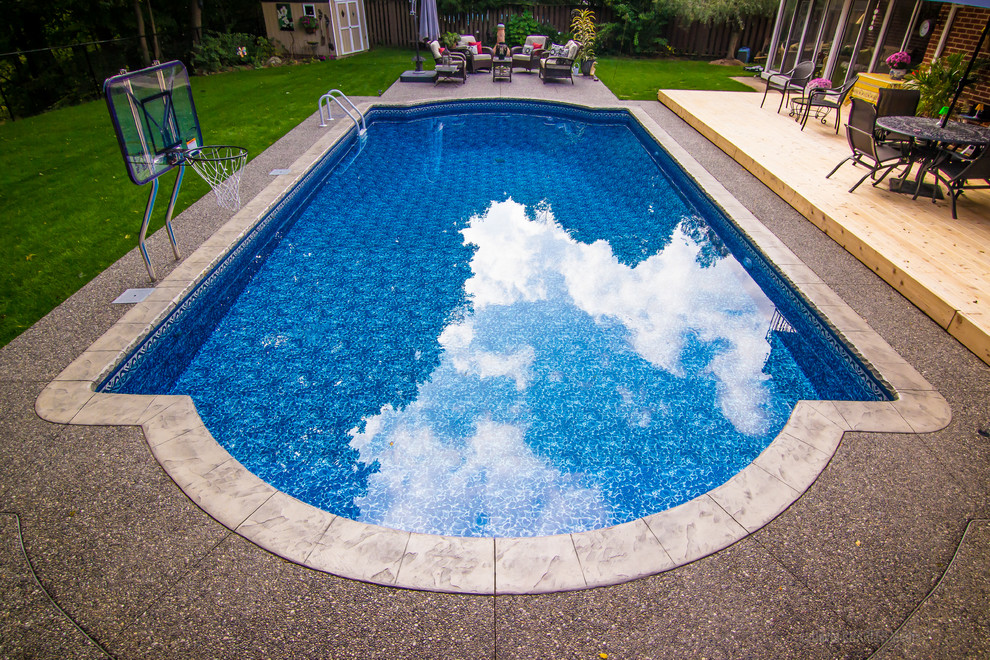 Design ideas for a medium sized contemporary back custom shaped swimming pool in Atlanta with concrete paving.