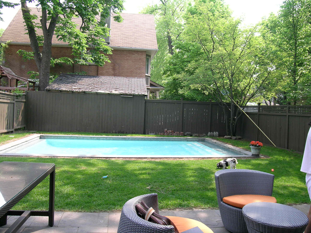 Inspiration for a medium sized modern back rectangular lengths swimming pool in Toronto with natural stone paving.