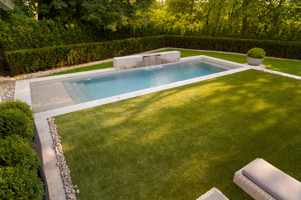 Example of a large trendy backyard concrete and rectangular lap pool fountain design in Toronto