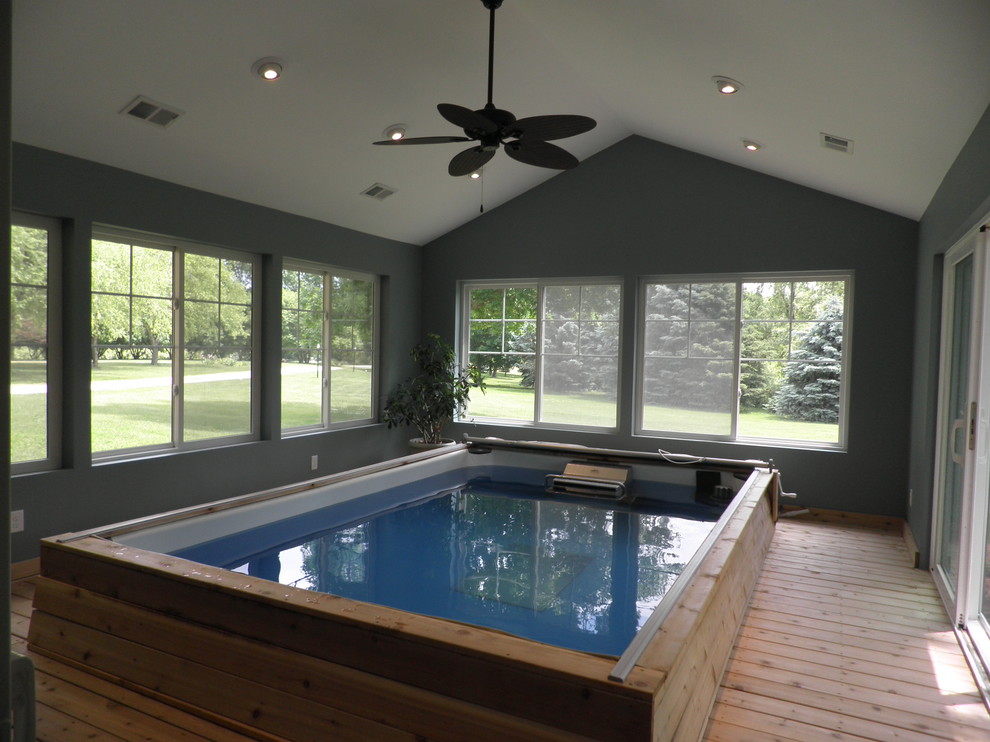 Mid-sized elegant indoor rectangular pool photo in Minneapolis with decking