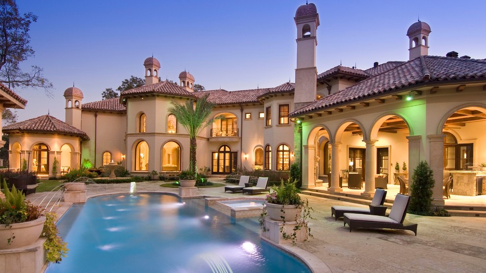 Inspiration for a mediterranean backyard tile and custom-shaped lap pool house remodel in Houston