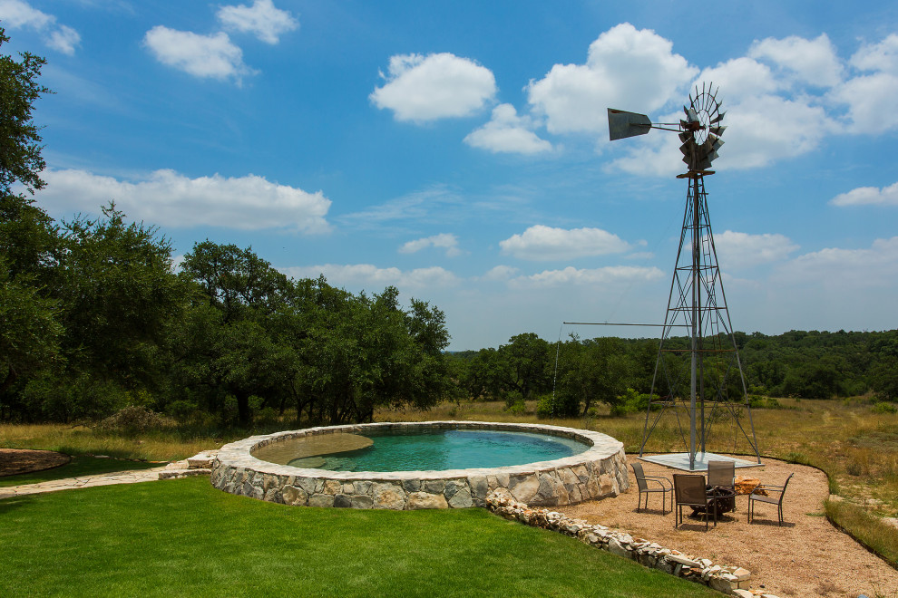 Pool - rustic backyard round pool idea in Austin