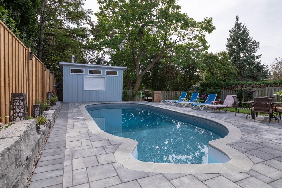 Minimalist backyard custom-shaped and brick pool photo in Toronto
