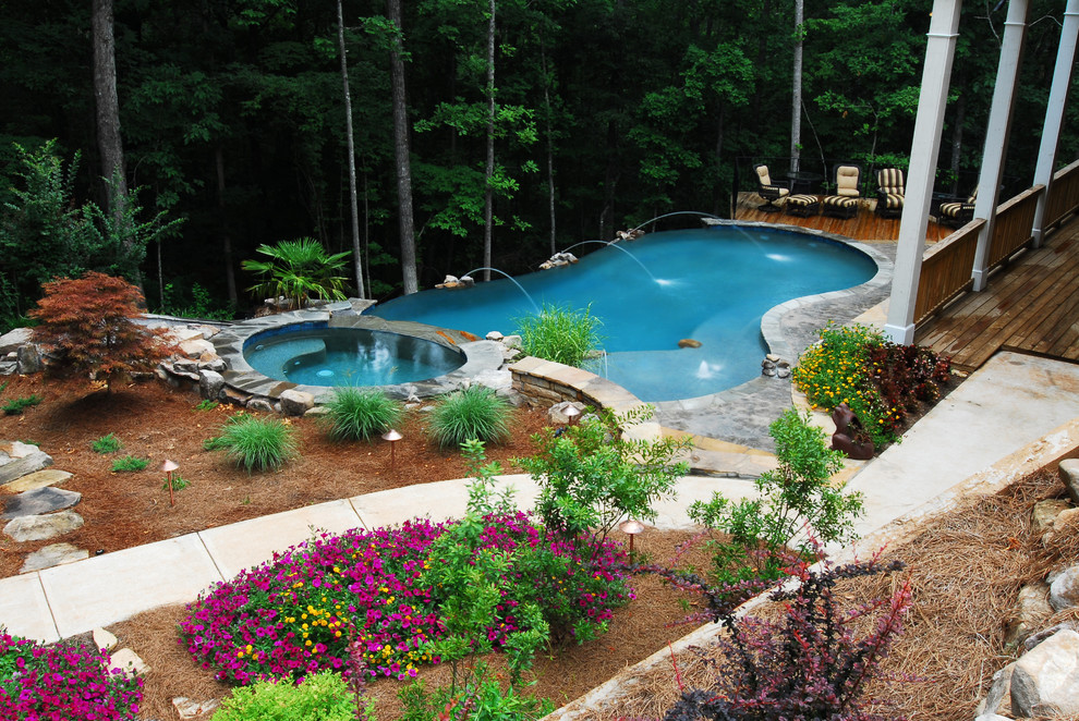 Inspiration for a large rustic backyard kidney-shaped infinity water slide remodel in Atlanta