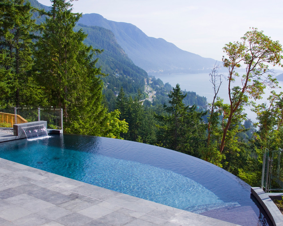 Inspiration for a rustic backyard rectangular infinity pool remodel in Vancouver