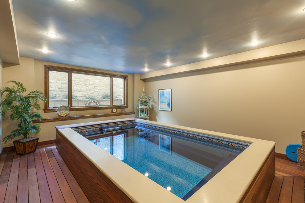 Design ideas for a rustic indoor rectangular swimming pool in Denver with decking.