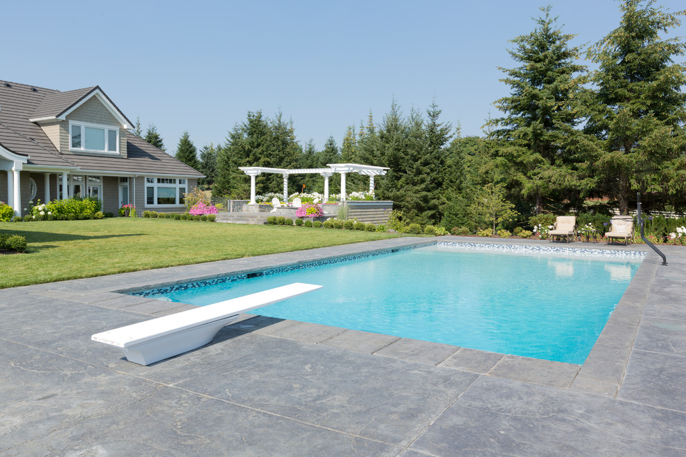 Immagine di una piscina monocorsia tradizionale personalizzata di medie dimensioni e dietro casa con cemento stampato