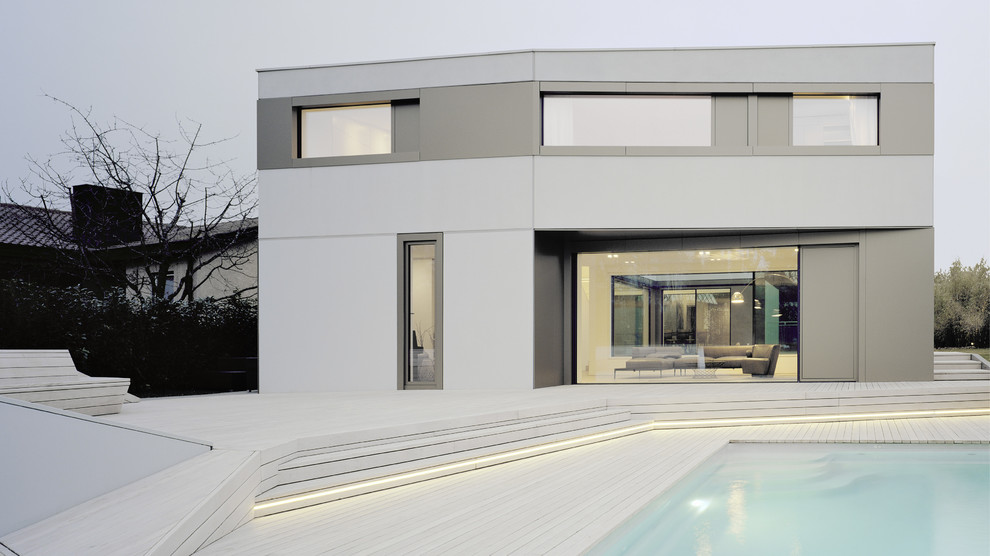 Photo of a medium sized contemporary back rectangular lengths swimming pool in Stuttgart with decking.