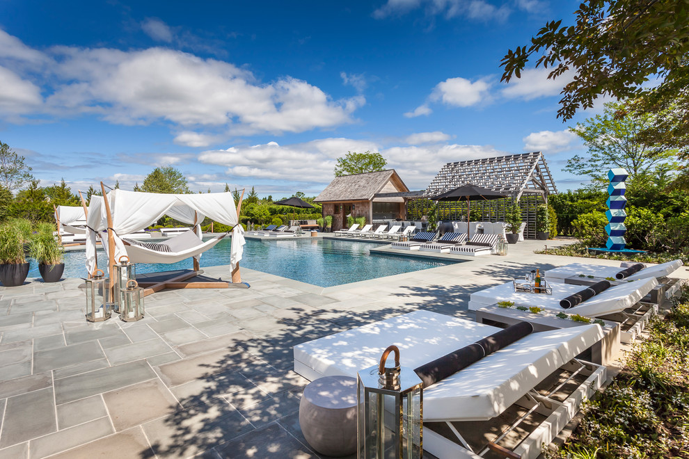 Photo of a large contemporary back custom shaped swimming pool in New York.