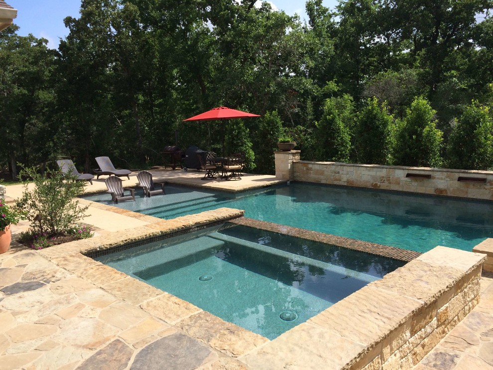 Design ideas for a medium sized traditional back rectangular lengths hot tub in Dallas with natural stone paving.