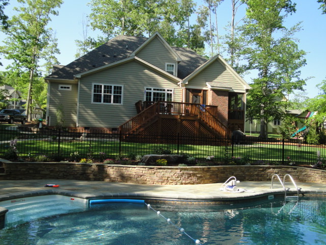 Esempio di una grande piscina naturale moderna a "C" dietro casa con una dépendance a bordo piscina e pavimentazioni in pietra naturale