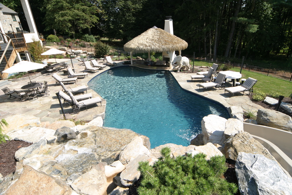 Salt water pool with grotto, waterslide, swim up bar in PA - Tropical ...