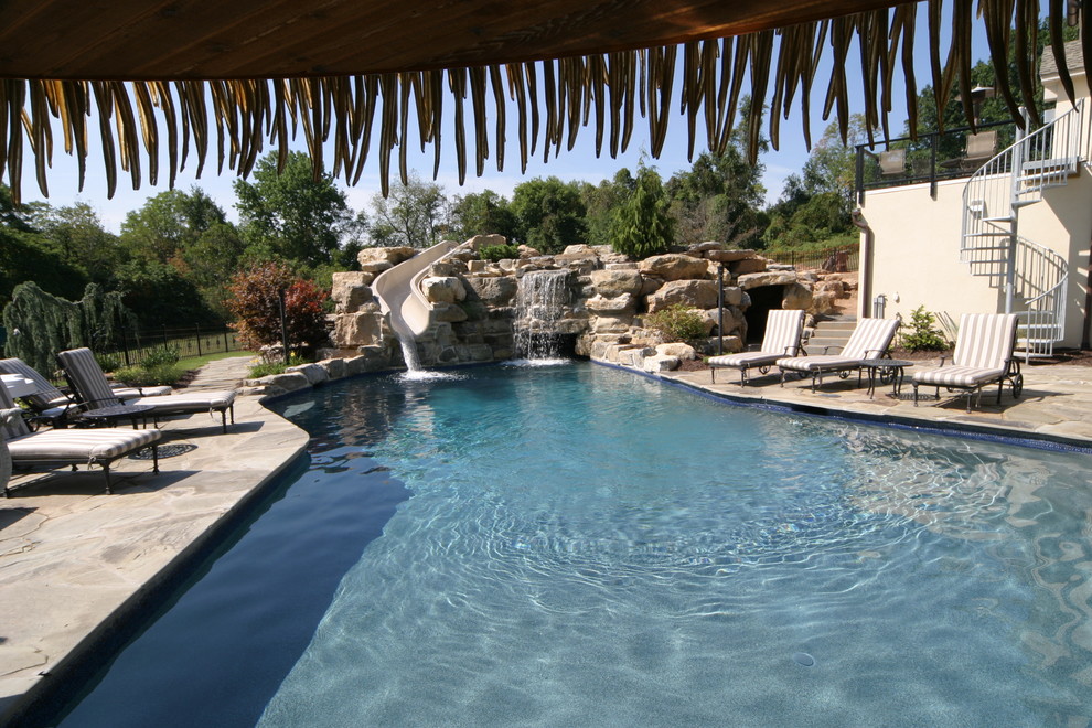 Salt water pool with grotto, waterslide, swim up bar in PA Tropical Pool Philadelphia by