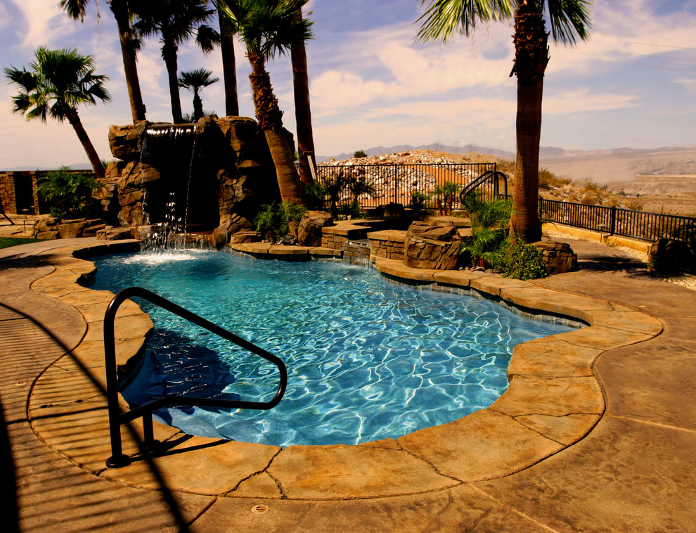 Inspiration for a large coastal backyard stamped concrete and custom-shaped natural pool fountain remodel in Las Vegas