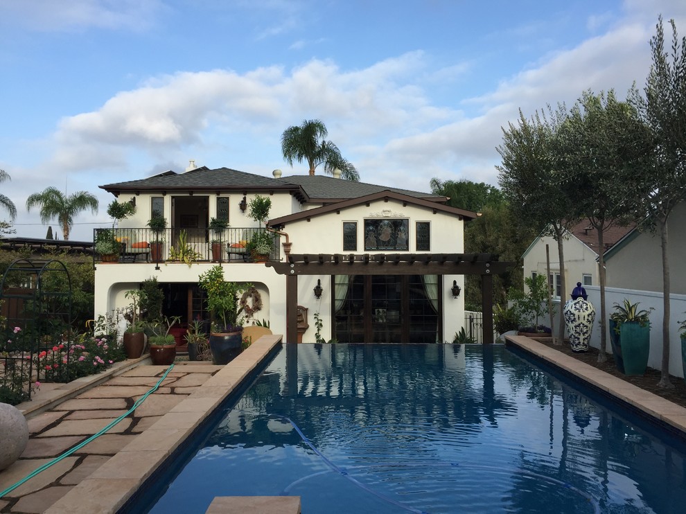 Large tuscan backyard stone and rectangular lap pool photo in San Diego