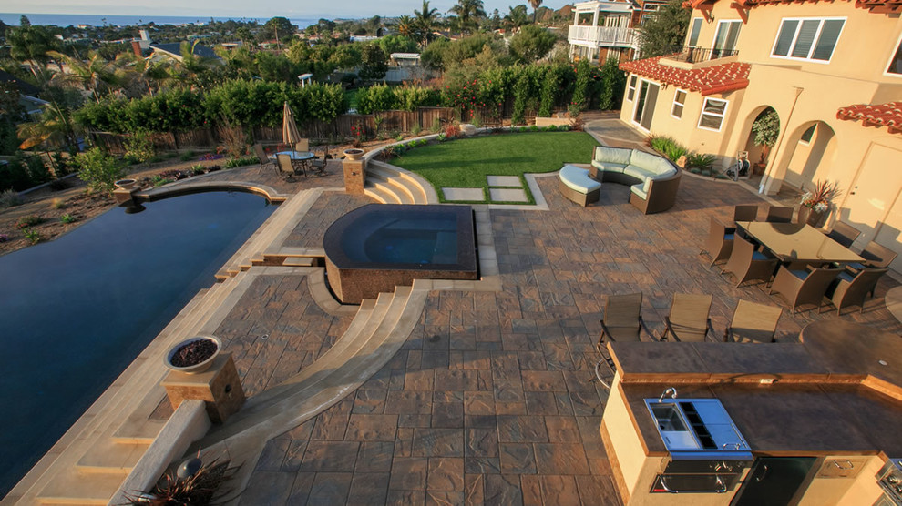 Hot tub - large contemporary backyard concrete paver and kidney-shaped infinity hot tub idea in San Diego
