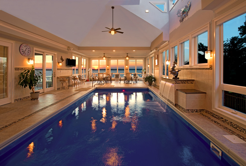 Photo of a large traditional indoor rectangular lengths swimming pool in Other with tiled flooring and a water feature.