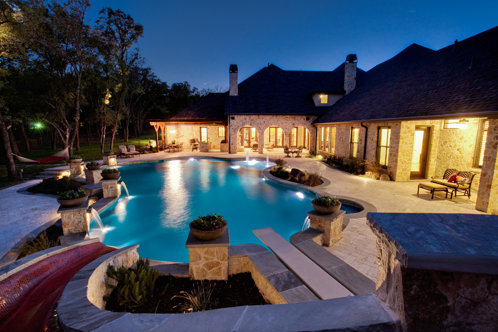 Example of a large tuscan backyard concrete paver and custom-shaped natural pool fountain design in Dallas