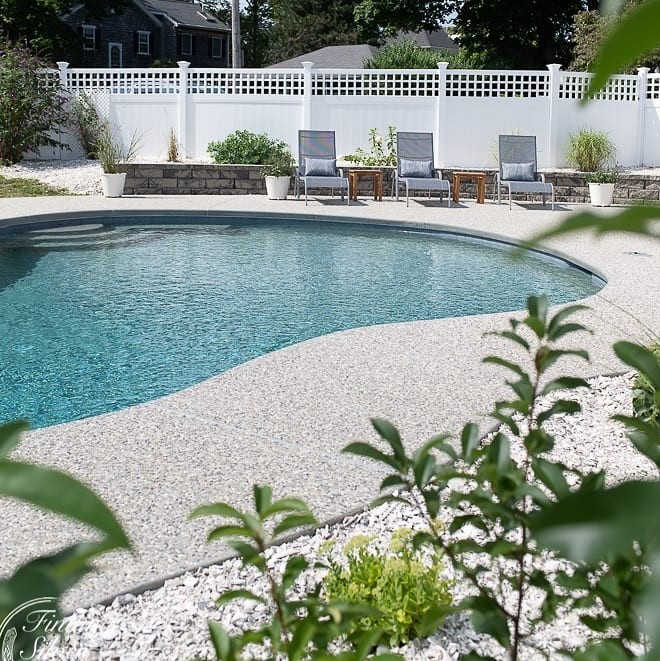 Medium sized modern back kidney-shaped natural swimming pool in Boston with concrete slabs.