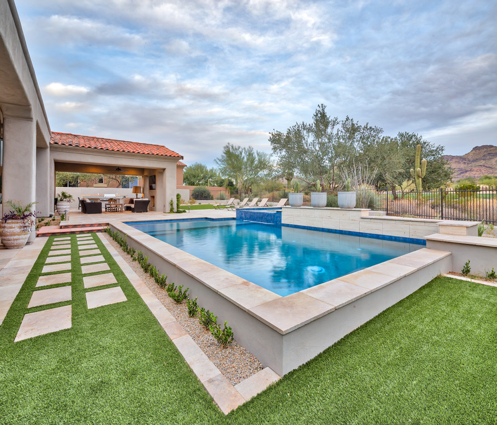 Example of a large trendy backyard concrete paver and rectangular natural pool design in Phoenix