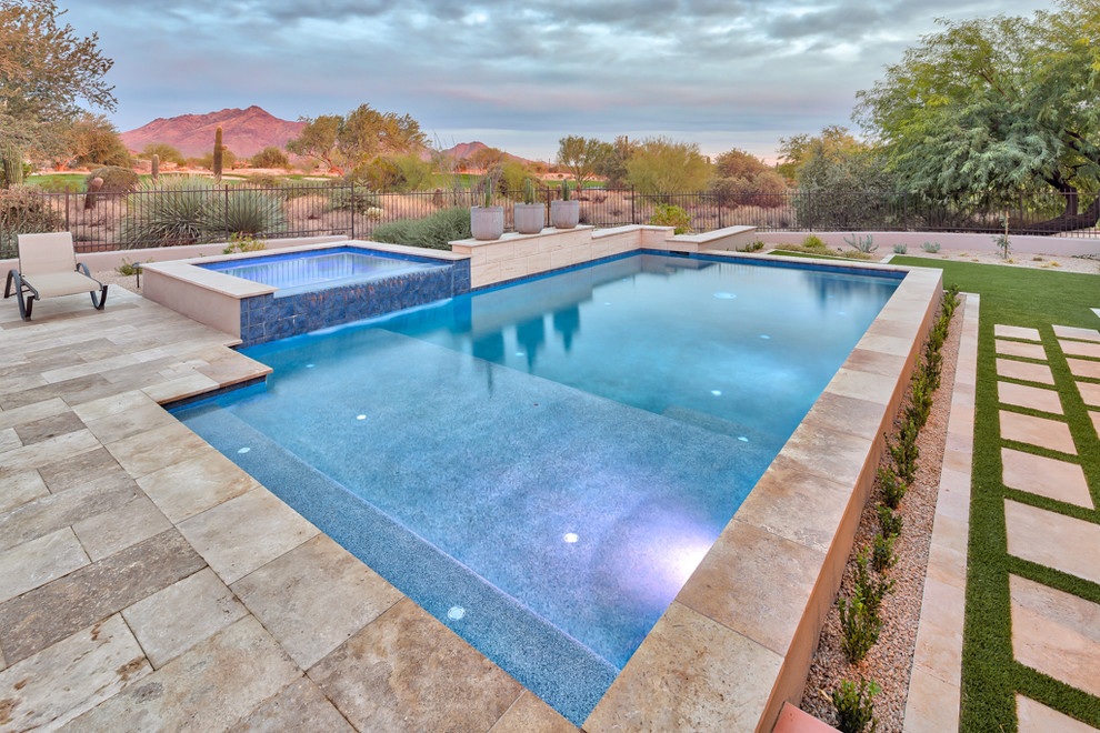 Large trendy backyard concrete paver and rectangular natural pool photo in Phoenix
