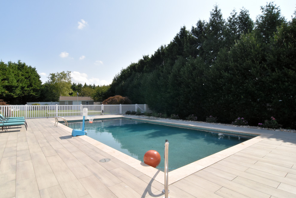 Design ideas for a large classic side rectangular swimming pool in Other with tiled flooring.