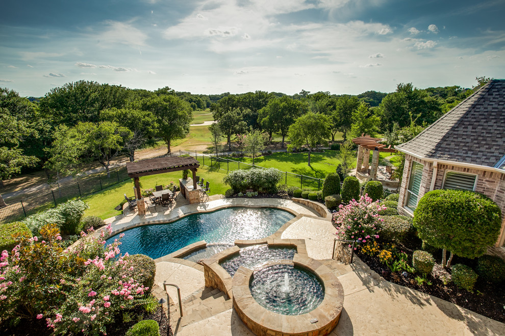 Classic custom shaped swimming pool in Dallas with fencing.