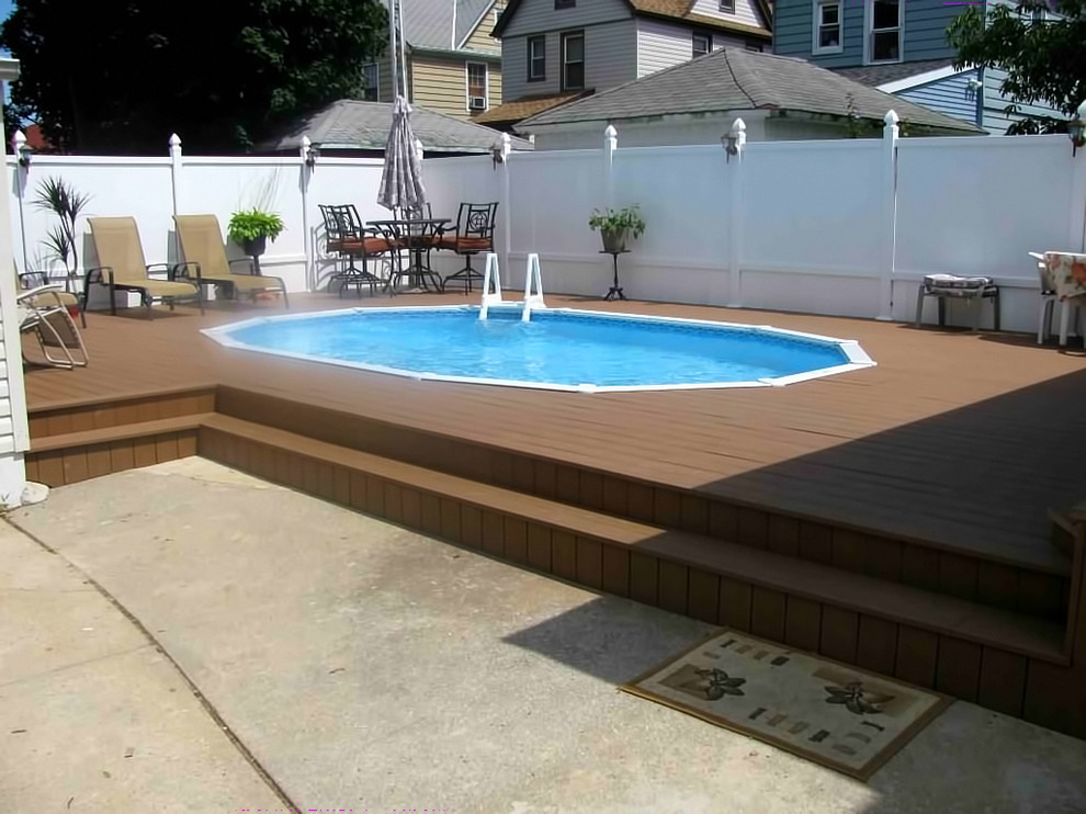 Mid-sized elegant backyard round aboveground pool photo in New York with decking
