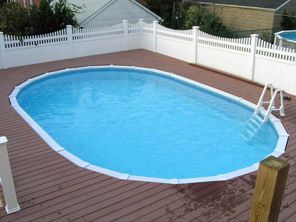Design ideas for a medium sized traditional back round swimming pool in New York with concrete paving.