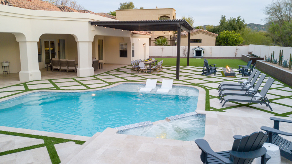 Design ideas for a medium sized modern back custom shaped swimming pool in Phoenix with natural stone paving.