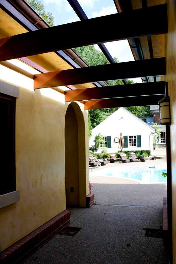Pool house - huge mediterranean courtyard custom-shaped pool house idea in Other